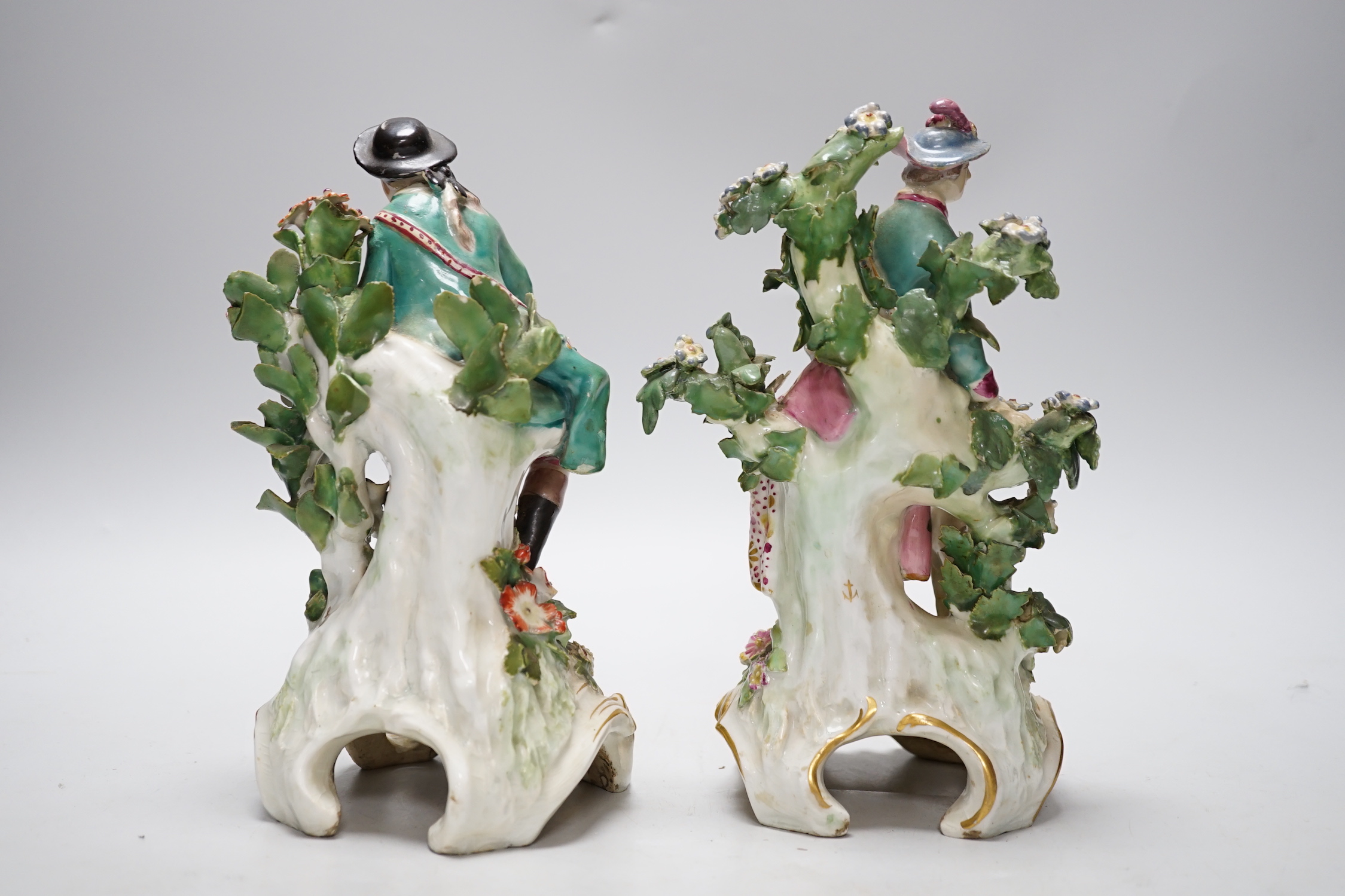 A pair of Chelsea gold anchor period figures wearing 18th century dress, c.1760-65, 22cm